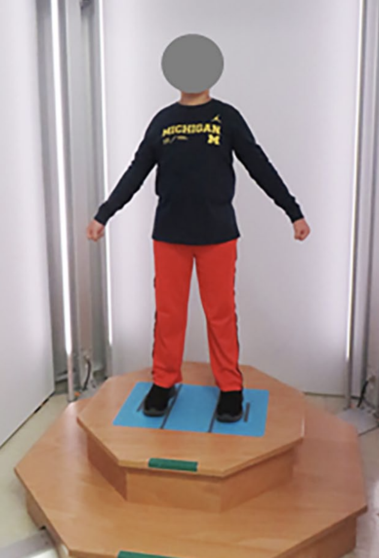 Child in Michigan clothing in a 3d scanner